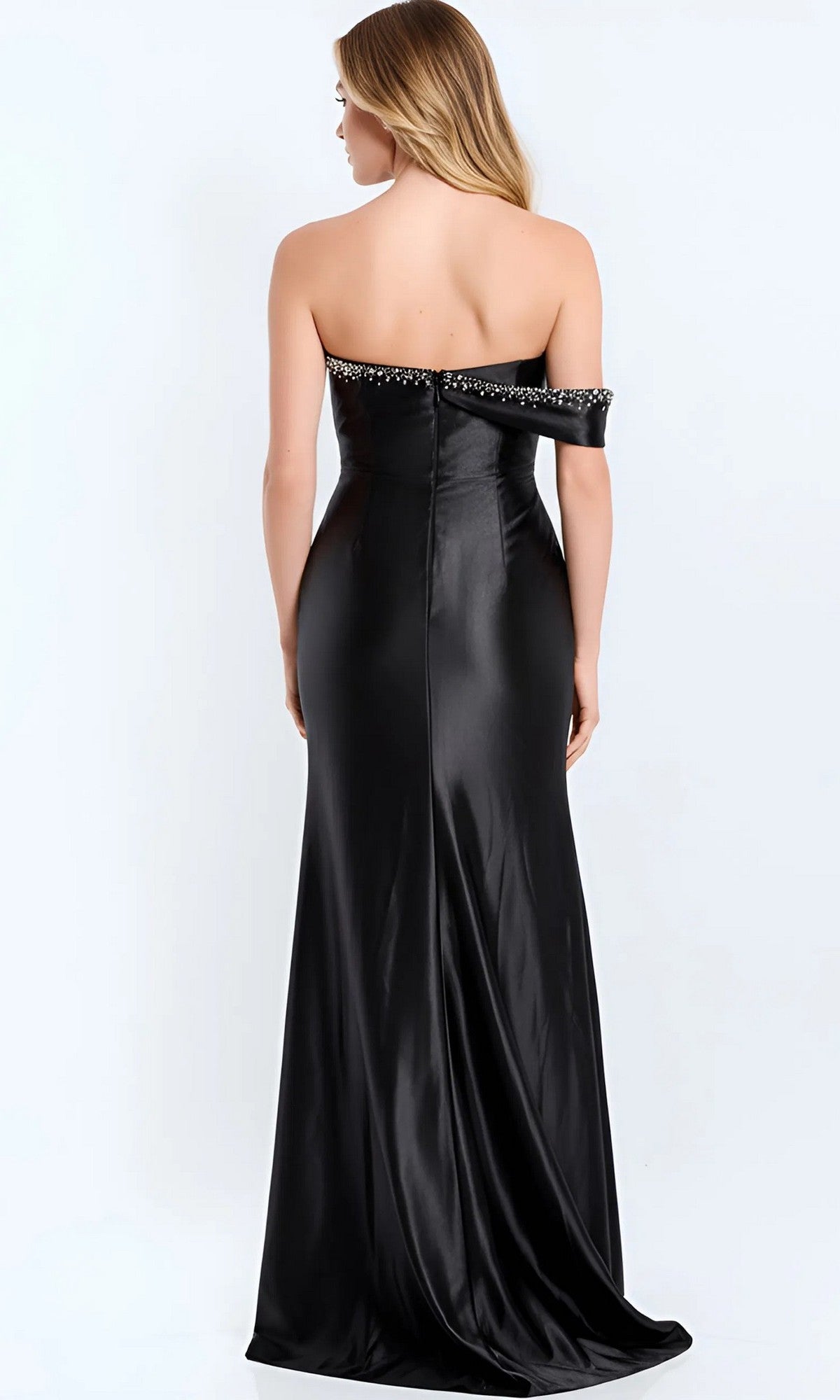 A woman wearing the Jovani 47607 long prom dress with an off-the-shoulder neckline and beaded trim stands facing away against a plain light background.